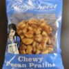 Photo of a Katy Sweet Chew Pecan Praline in a plastic wrapper.
